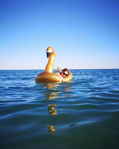 Young woman with inflatable raft in sea