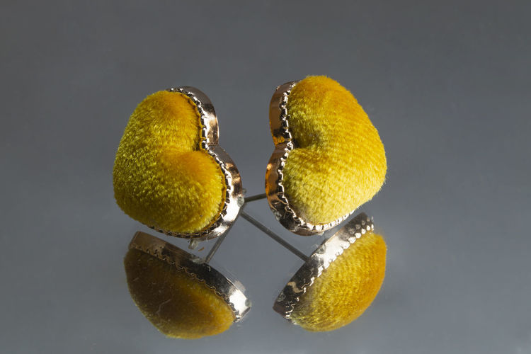 Close-up of earring against gray background