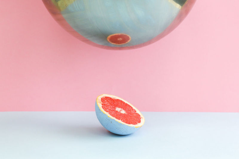 CLOSE-UP OF APPLE AGAINST GRAY BACKGROUND