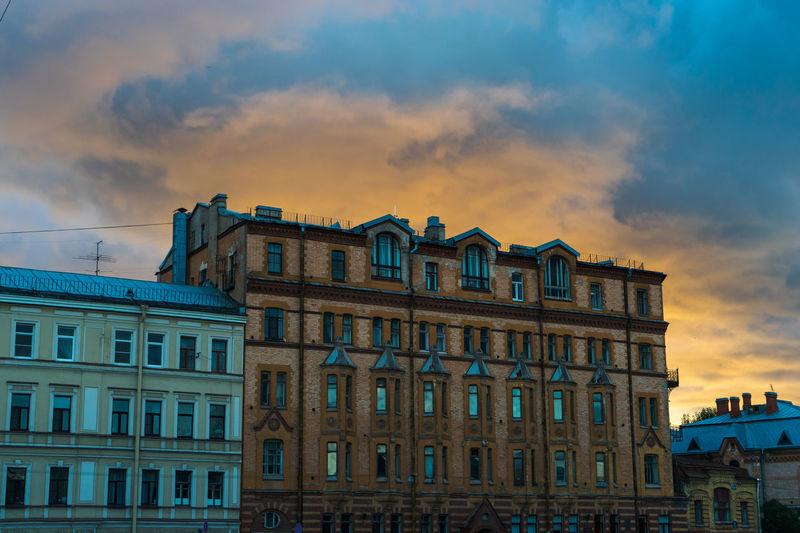 Low angle view of building against cloudy sky
