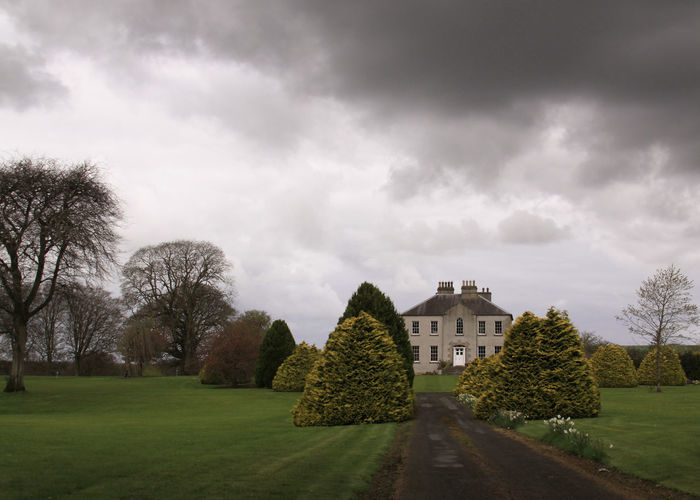 Haunted castle or house in ireland with dark clouds