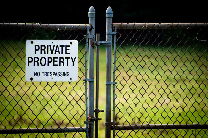 Warning sign on chainlink fence