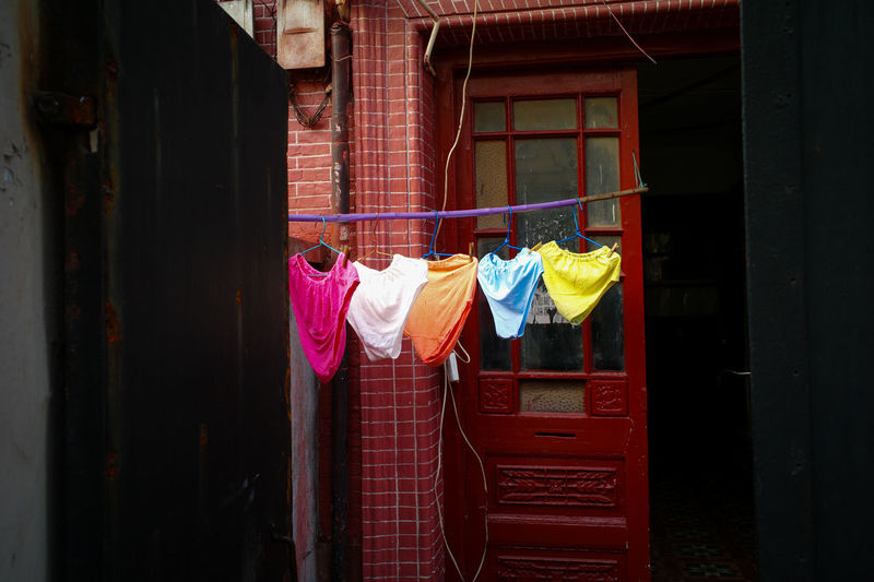 Rear view of clothes drying against building