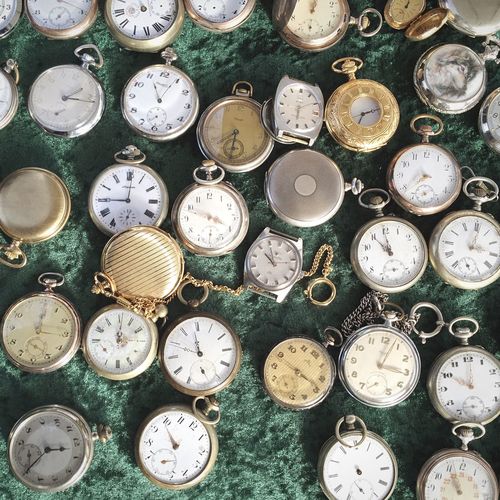 Directly above of old fashioned pocket watches in shop