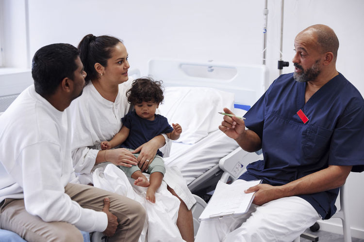 Parents with children in hospital room