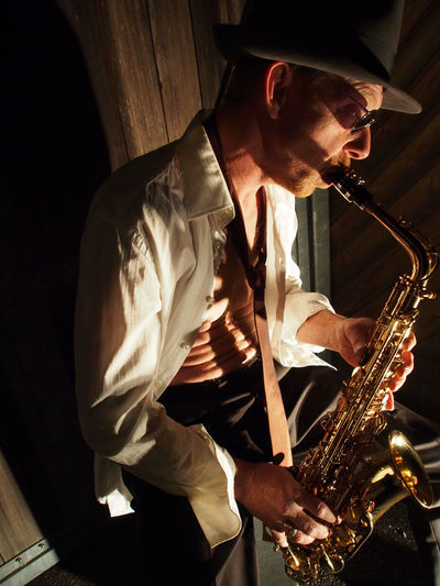 High angle view of mature man playing saxophone