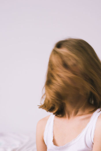 Woman shaking head against white background