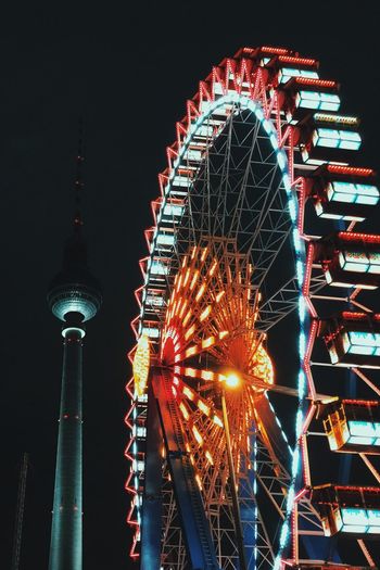 Low angle view of ferris wheel against sky at night