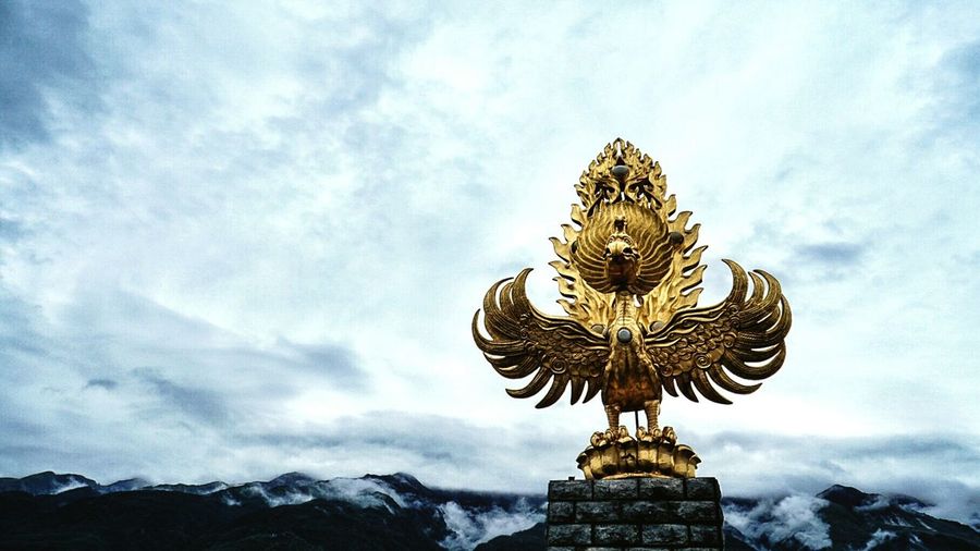 Close-up of golden sculpture of bird at chongsheng temple in china