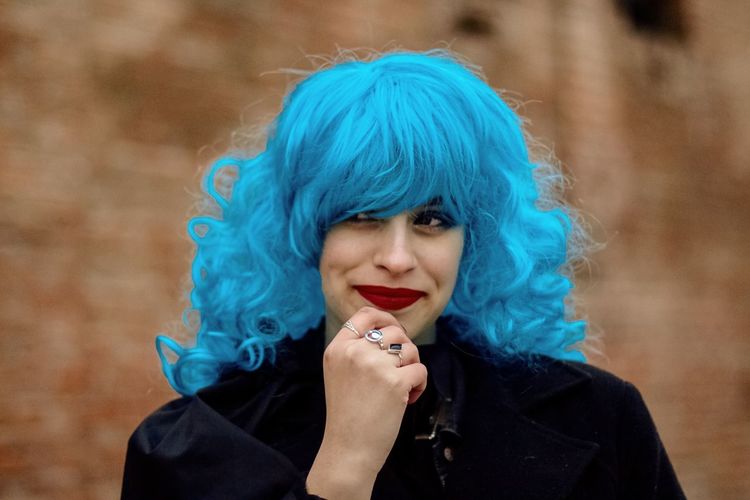 Close-up of young woman with blue hair