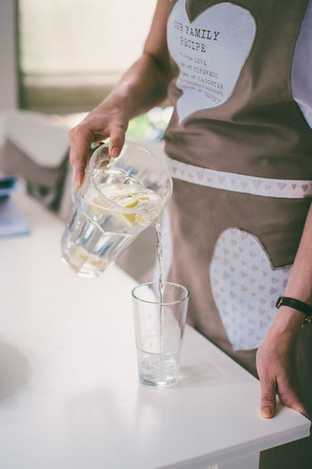 Midsection of scientist examining chemical in laboratory