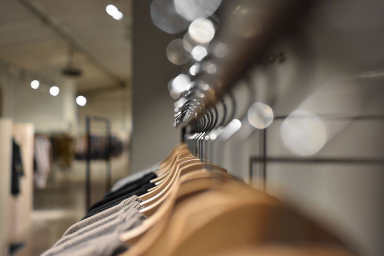 Close-up of clothes hanging on coathangers at store