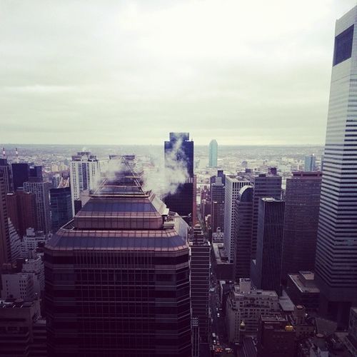 Skyscrapers against cloudy sky