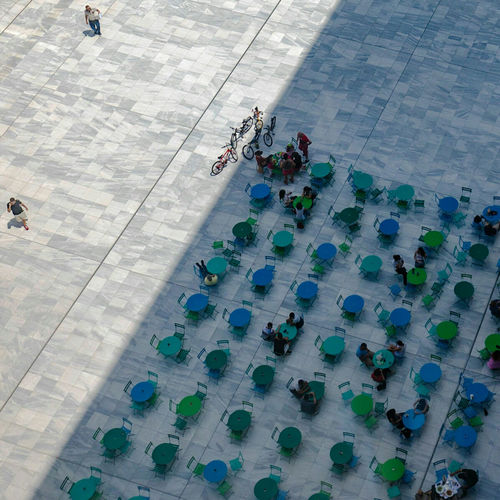 High angle view of people on floor in city