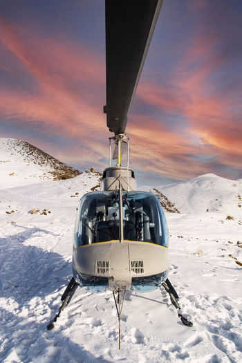 Helicopter in the alps at sunset