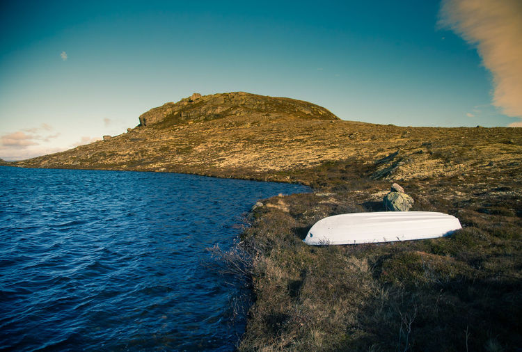 Scenic view of sea and rock against sky