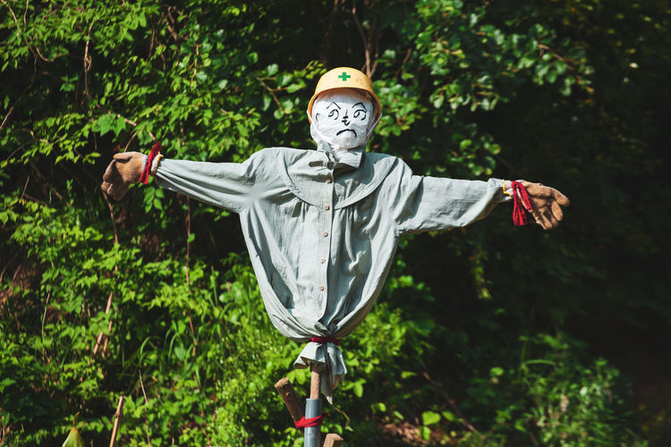Scarecrow with arms wide open in a field