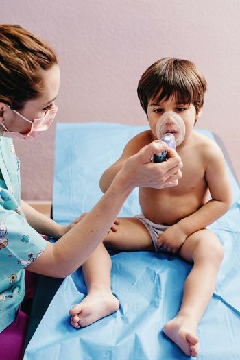 Sick boy getting inhalation treatment in clinic