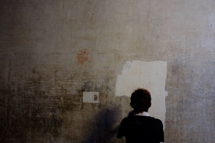 Woman standing against wall