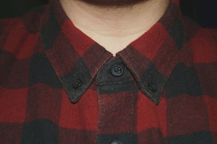 Midsection of man wearing checked shirt