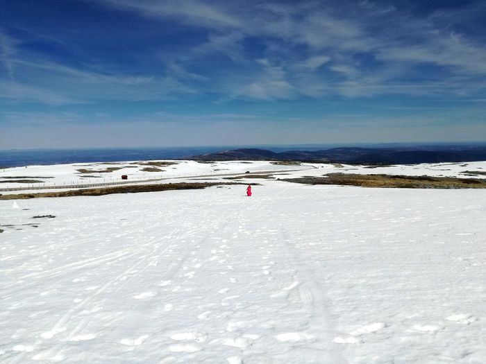 Scenic view of snow covered beach against sky