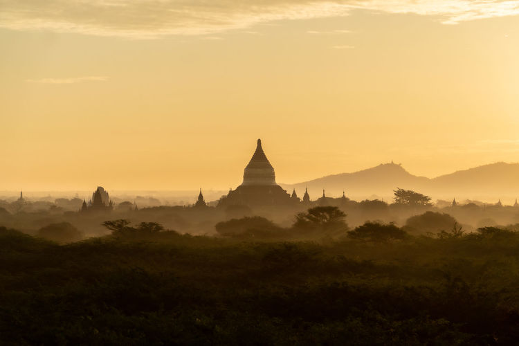View of pagoda against sky during sunrise