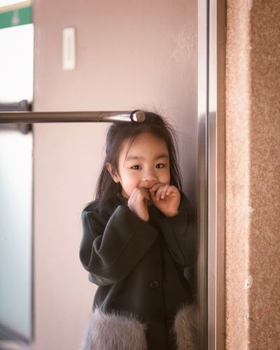 Portrait of girl seen through window