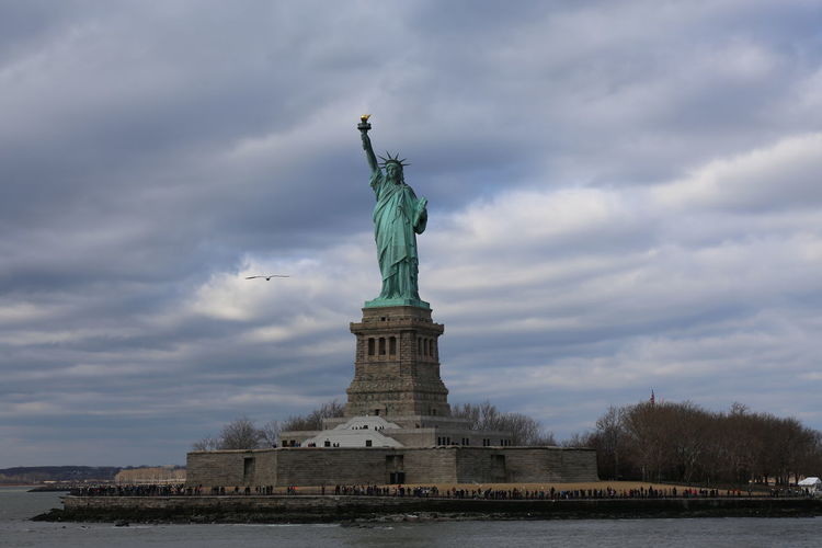 Statue of liberty against cloudy sky