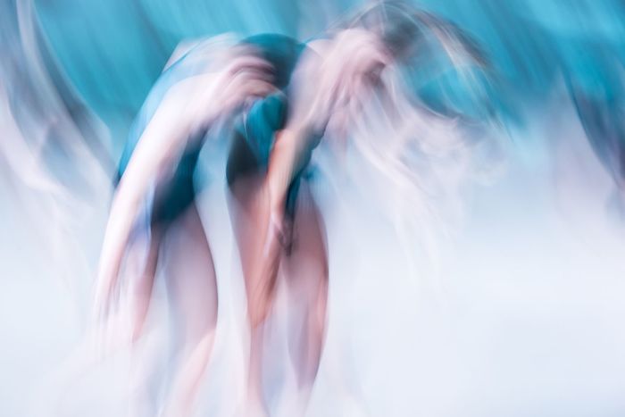Blurred motion of ballerinas during dance performance