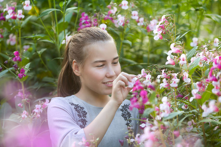Portrait of cute girl with pink flowers