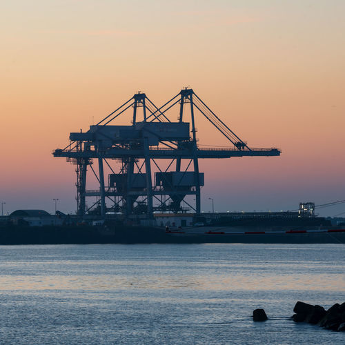 Sines container port terminal with cranes at sunset, in portugal