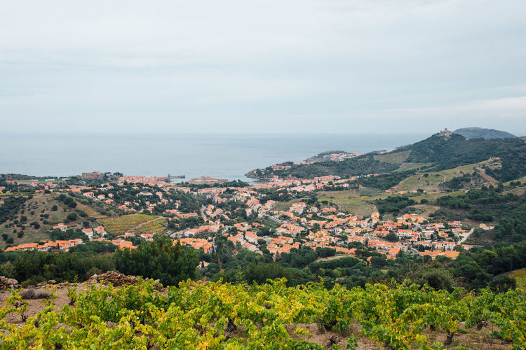 High angle view of townscape by sea against sky
