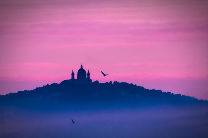 Silhouette of temple against sky during sunset