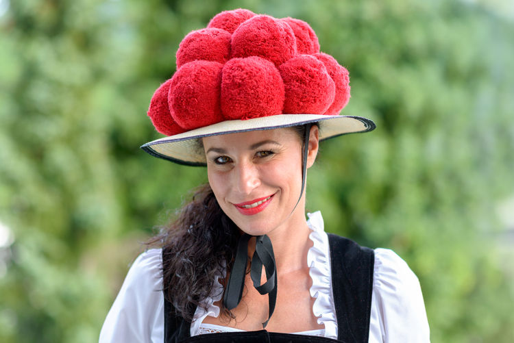 Close-up portrait of confident waitress wearing hat outdoors