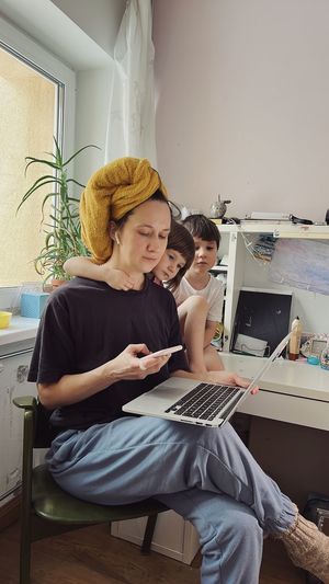 Young woman using laptop at home