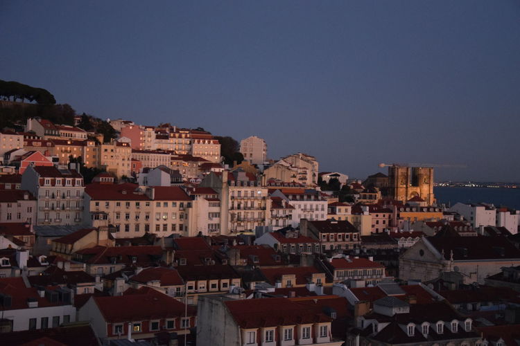 Houses in town against clear sky