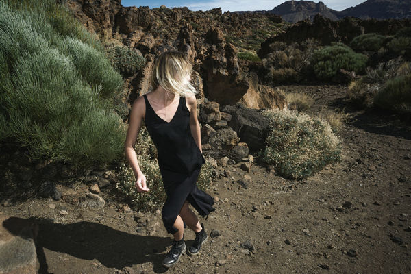 Full length of woman walking on field against sky