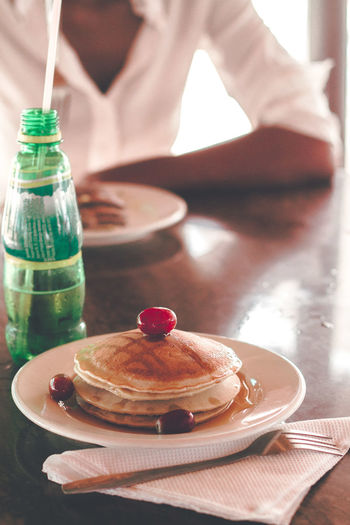 Close-up of pancake and drink on table