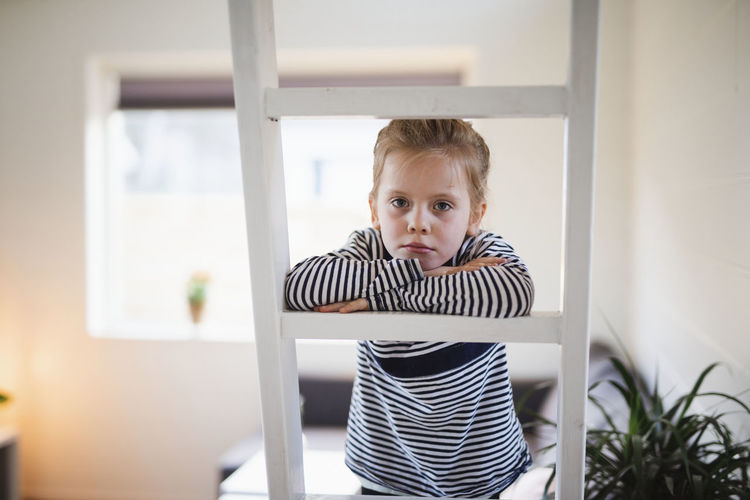 Girl on ladder looking at camera