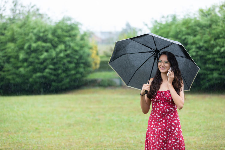 Portrait of woman holding umbrella
