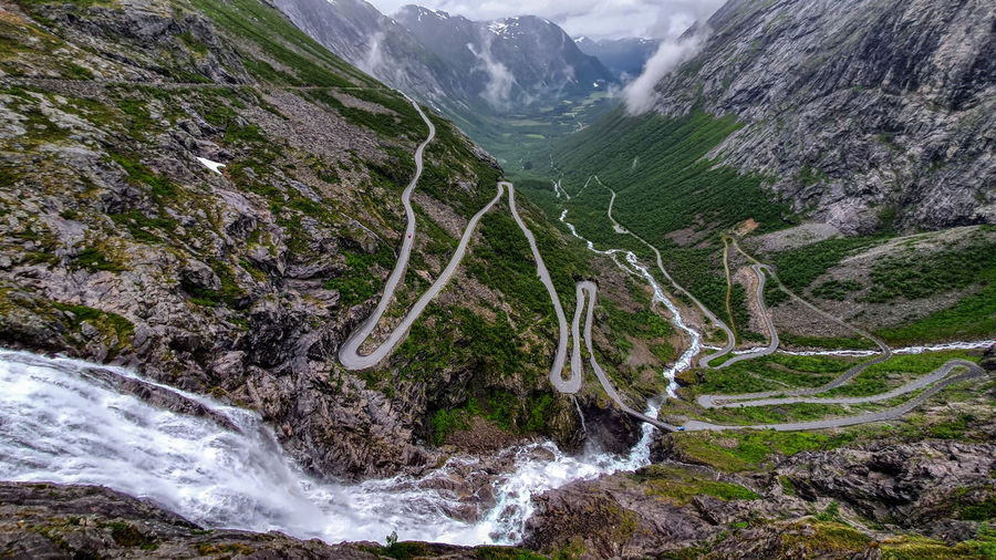 Scenic view of waterfall and a winding road