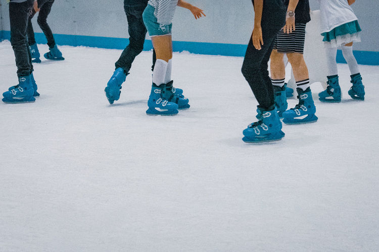 Low section of people ice skating