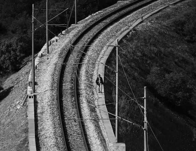 High angle view of man walking on railway tracks