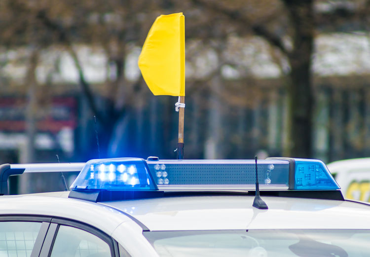Close-up of yellow flag on police car