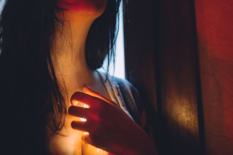 Woman with a light shining down her throat