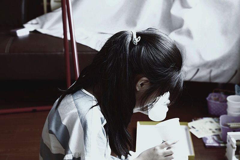 High angle view of girl studying at home