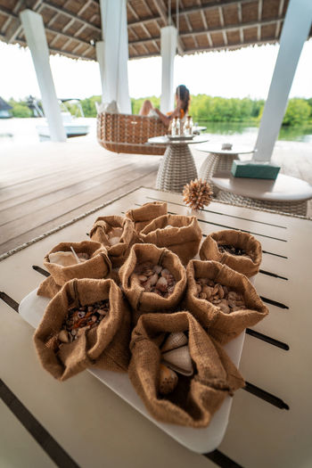 High angle view of sea shells in sack on table