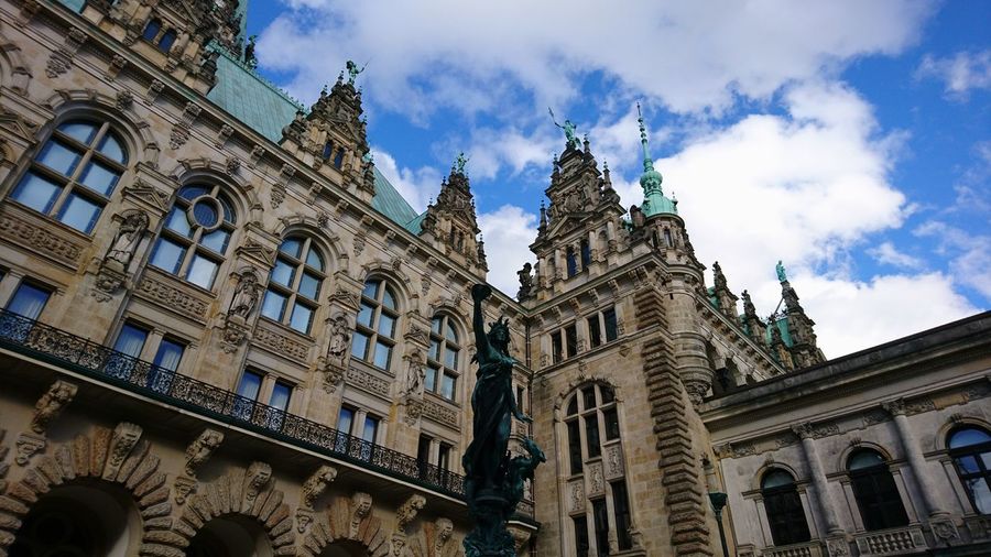 Low angle view of historical building against cloudy sky