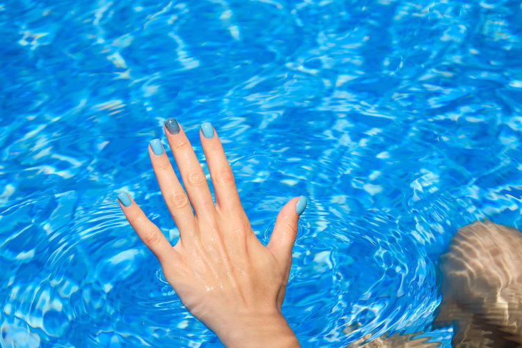 Cropped image of woman in swimming pool