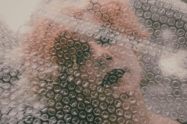 Closeup of woman seen through bubble wrap